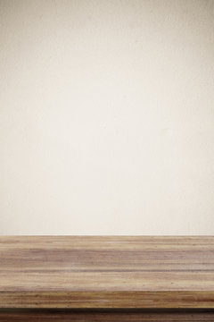 Empty wooden table over brown cement wall  background