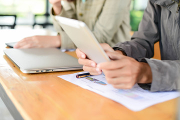 Woman typing text message on smart phone in a cafe. Cropped imag
