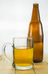 Beer bootle and mug on white background
