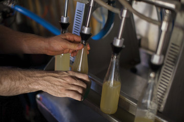 Man filling bottles of juice