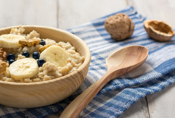 Oatmeal with bananas and blueberries on a checkered towel
