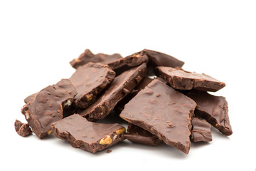 broken dark chocolate with nuts on white background