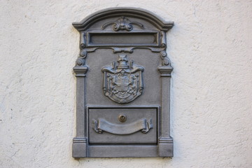 Letterbox on gray house wall 