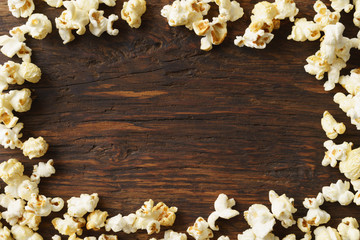 Frame of popcorn on wood background with copyspace - obrazy, fototapety, plakaty