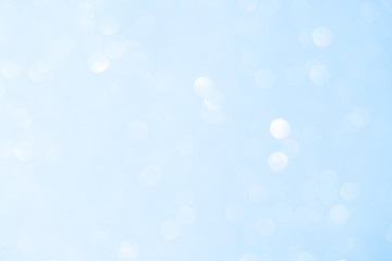 Unfocused abstract light blue glitter bokeh holiday background. Winter xmas holidays. Christmas.