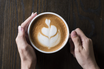 Hot latte art on wood table