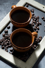two cups of black coffee on the blackboard, top view vertical