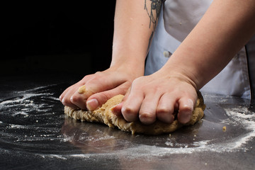 Woman hands kneading dough.