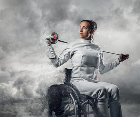 Female fencer in wheelchair with safety mask of a face holding r