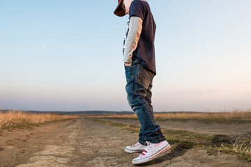 boy on dusty road to horizon