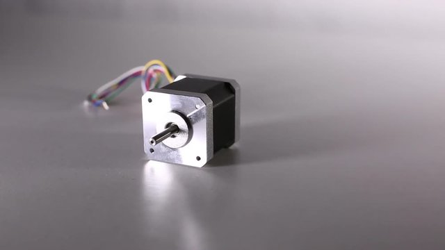 The stepper motor is on the white table.