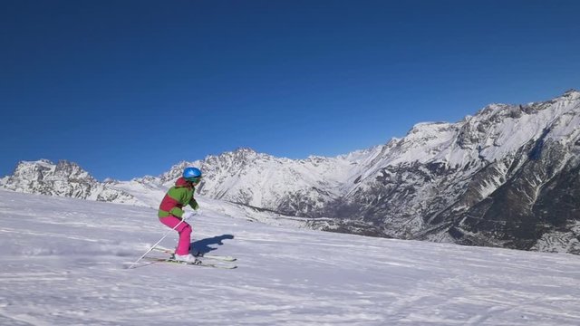 TS HD Slow-Mo: Teen Girl Skiing Dowhill on Sunny Day
