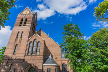 Naklejka premium church front view with clocktower and trees