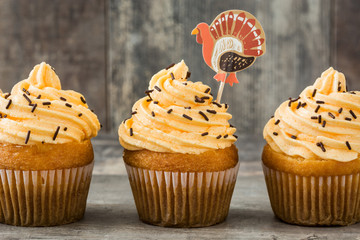 Thanksgiving cupcakes on wooden background

