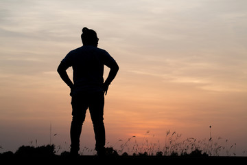 Silhouette man with beautiful the sky at sunset..Background,