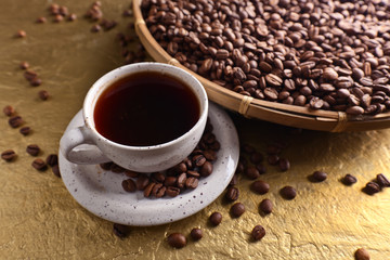 Cup of black coffee and  beans