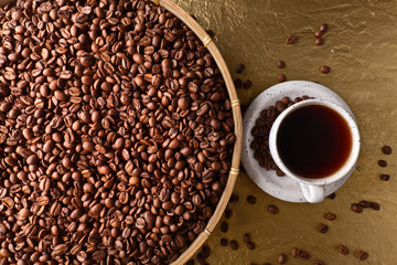 Cup of black coffee and  beans