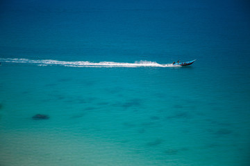 The boat in the azure ocean
