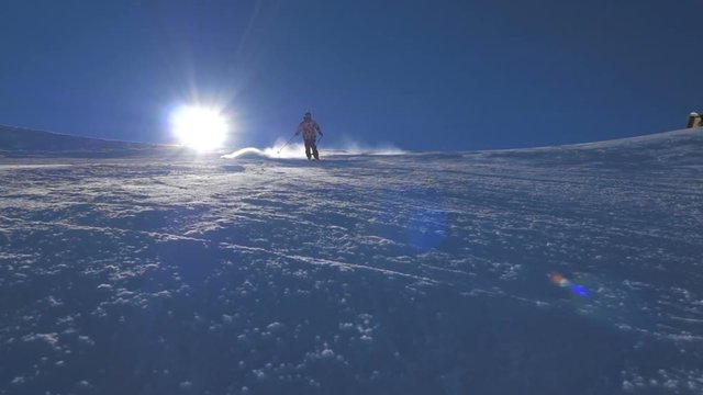 WS HD Slow-Mo: Man Skiing Downhill and Spray Snow ON Sunny Day
