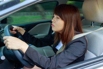 Fototapeta na wymiar Closeup portrait sleepy, tired, close eyes young woman driving