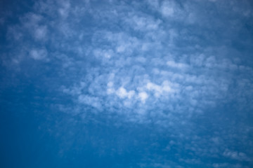 White clouds on a blue sky. Selective focus. Toned