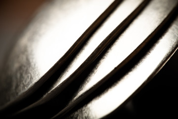 Lot of metal cutlery on a black background. Selective focus. Sha