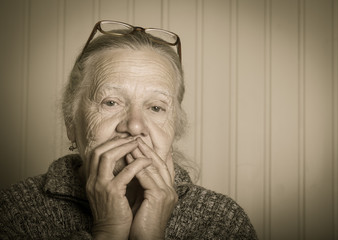 Portrait of elderly woman in glasses. Toned
