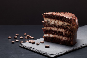 Chocolate cake on slate plate on black background. Selective foc