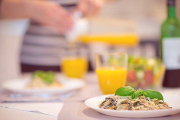Fresh spaghetti with creamy mushroom sauce and basil leaf