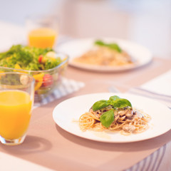 Fresh spaghetti with creamy mushroom sauce and basil leaf
