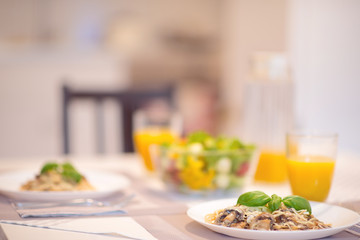 Fresh spaghetti with creamy mushroom sauce and basil leaf
