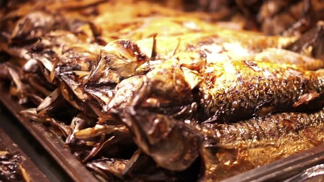 Pile of whole fish grilled with flame in the market