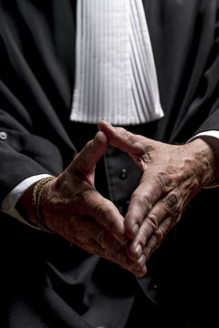 Lawyer in gown with jabot hands close up judge