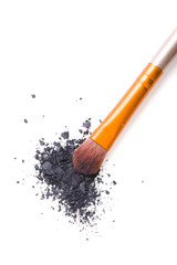 Professional makeup brush and loose powder eyeshadows isolated