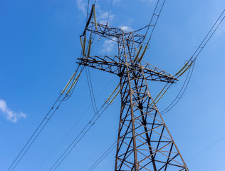 Electricity transmission power lines at sun.