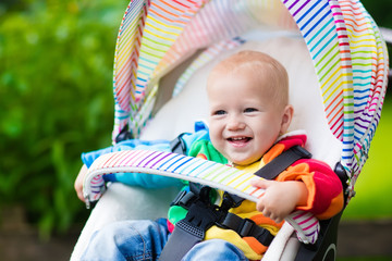 Baby boy in white stroller