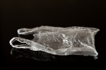 Naklejka premium White Plastic Bag Isolated on Black Background