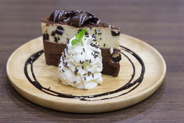Delicious chocolate cake on wood plate. Homemade cake served wit