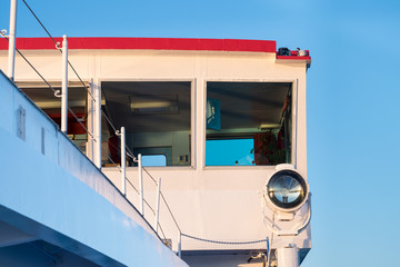 Wheelhouse of river vessel in background of blue sky