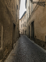 Fototapeta na wymiar Buildings along a narrow cobblestone street, Orvieto, Terni Prov