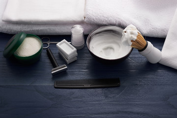 foam, shaving brush and shaving blade on the table