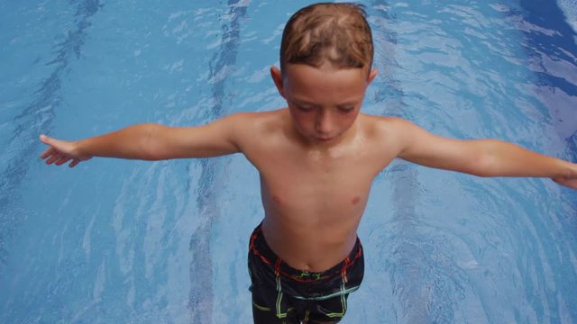 Boy falling into pool