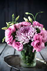 Bouquet of pink flowers in vase vintage decor