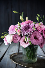 Bouquet of pink flowers in vase vintage decor