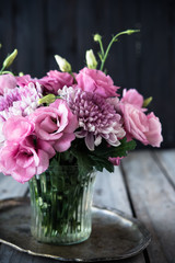 Bouquet of pink flowers in vase vintage decor