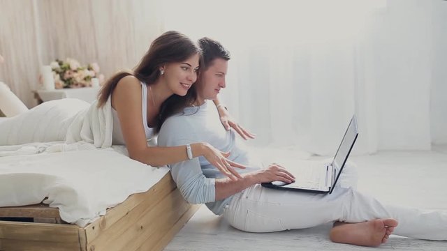man and girl with laptop at home