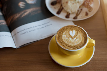 Hot latte art on wood table