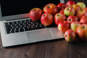 Laptop and apples on a table