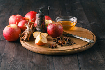 Apples, cinnamon, anise and clove with baking tin.