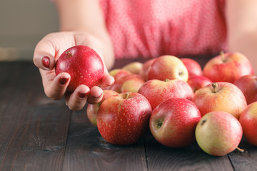 Woman hold Apples on wooden background